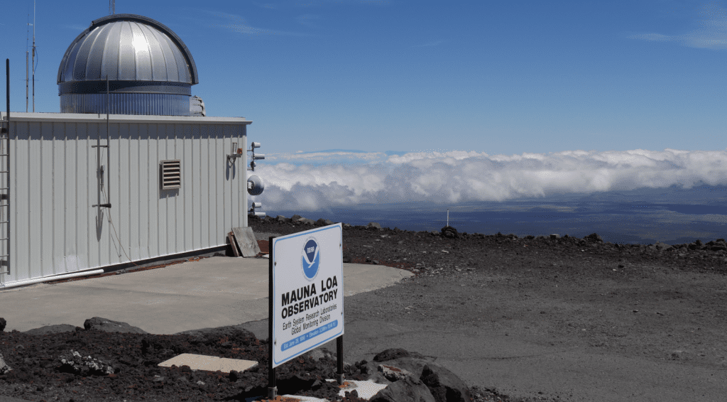 Outside of Mauna Loa observatory in Hawaii overlooking mountains