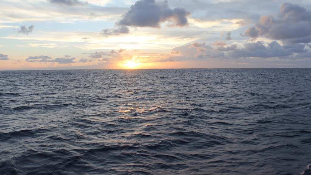 Sun setting over a fairly turbulent ocean