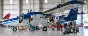 A photo of a blue and white NOAA Twin Otter research aircraft inside an Islip, N.Y. hangar in 2023 as scientists install instruments needed for air quality research flights.
